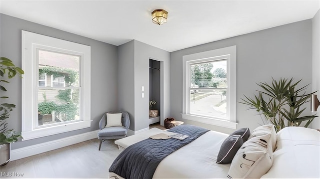 bedroom featuring hardwood / wood-style flooring and multiple windows