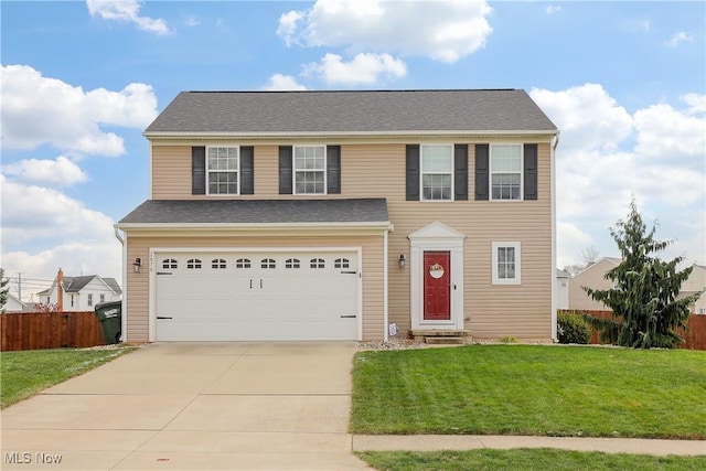 view of front of property featuring a front yard and a garage