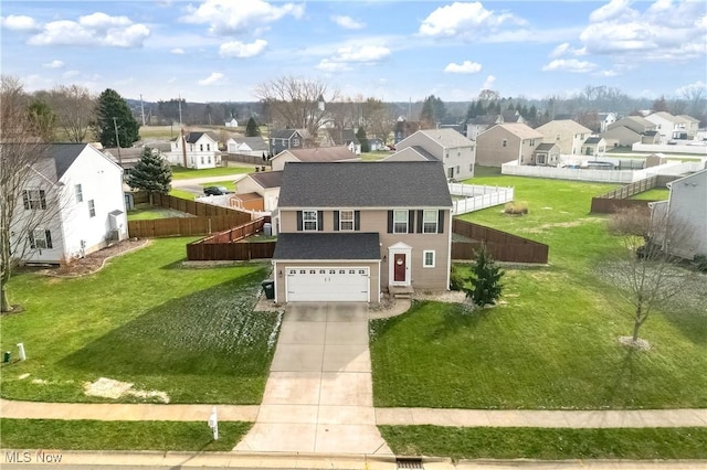 view of front of house featuring a front lawn and a garage