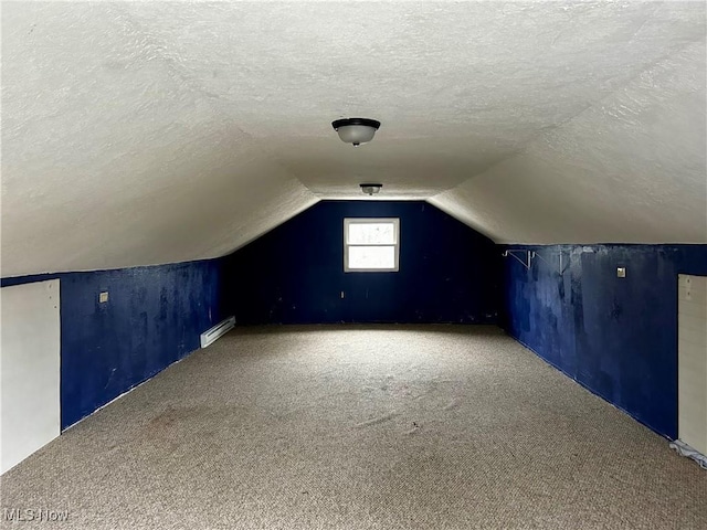 bonus room featuring carpet flooring, a textured ceiling, baseboard heating, and vaulted ceiling