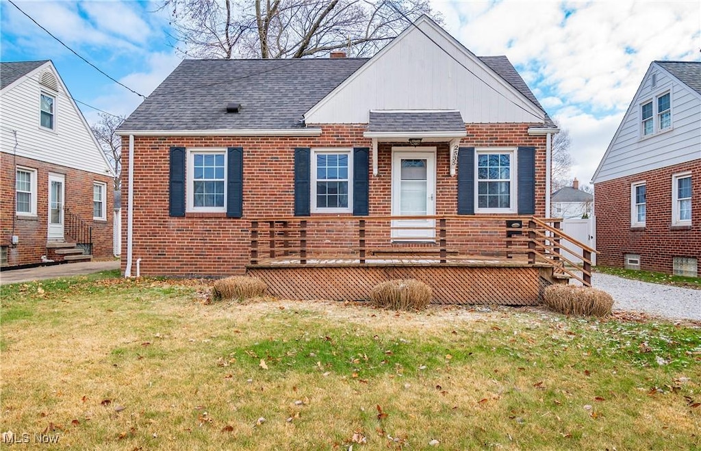 view of front of home with a front lawn and a deck