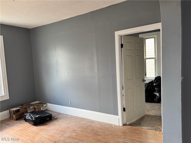 spare room featuring wood-type flooring