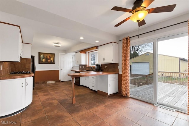 kitchen featuring black appliances, sink, ceiling fan, decorative backsplash, and white cabinetry