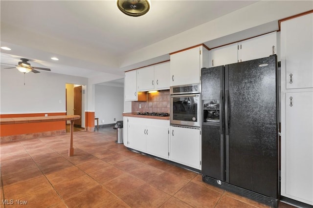 kitchen with white cabinetry, ceiling fan, stainless steel appliances, tile patterned flooring, and backsplash