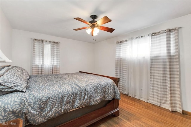 bedroom with hardwood / wood-style flooring and ceiling fan