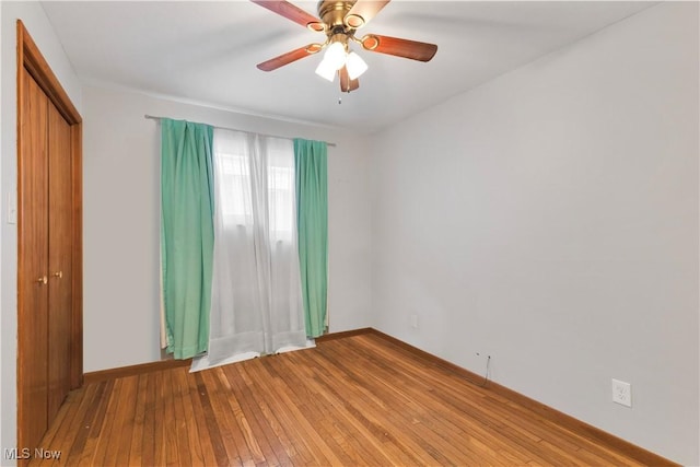 spare room featuring hardwood / wood-style floors and ceiling fan