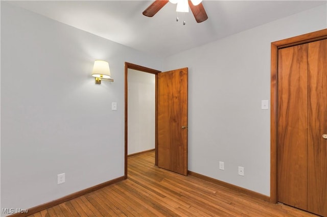 empty room with light wood-type flooring and ceiling fan