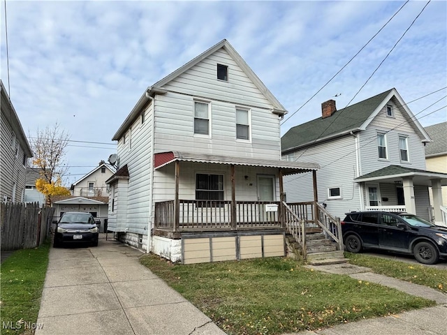 view of front of property featuring covered porch and a front yard