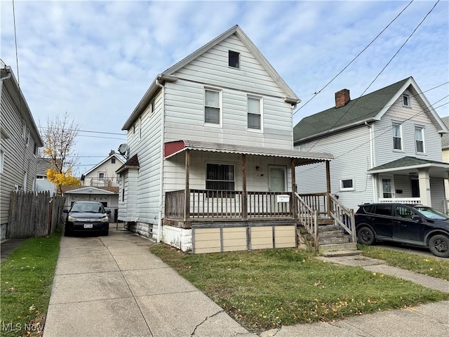 view of front of property featuring a porch, concrete driveway, and fence