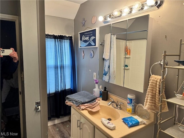 bathroom featuring a shower with curtain, wood finished floors, and vanity