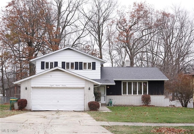 tri-level home with a front yard and a garage