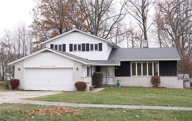 split level home with a front yard and a garage