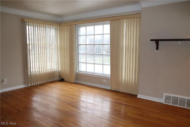 spare room with hardwood / wood-style floors