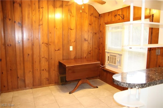 miscellaneous room featuring vaulted ceiling, cooling unit, ceiling fan, wooden walls, and light tile patterned flooring