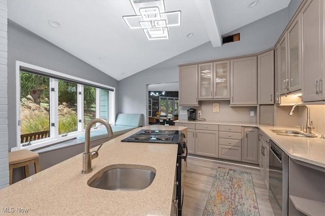 kitchen with dishwasher, light wood-type flooring, lofted ceiling with beams, and sink