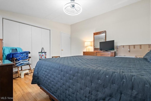 bedroom with a closet and light hardwood / wood-style flooring