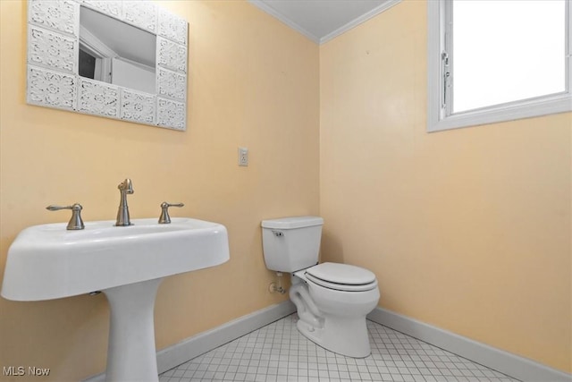 bathroom featuring toilet, ornamental molding, and sink