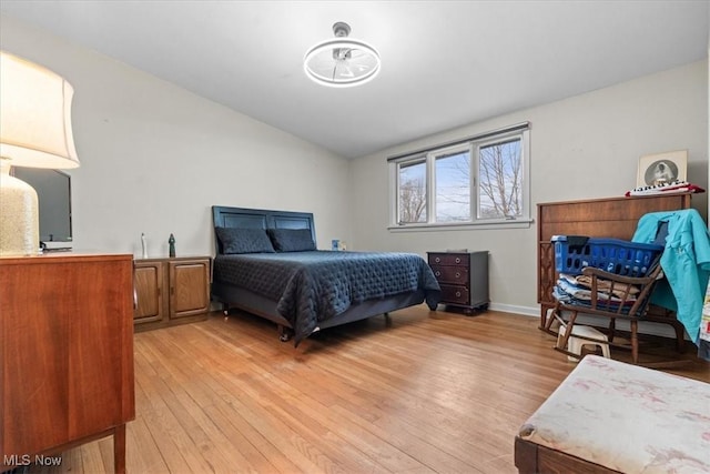 bedroom with light hardwood / wood-style flooring and vaulted ceiling