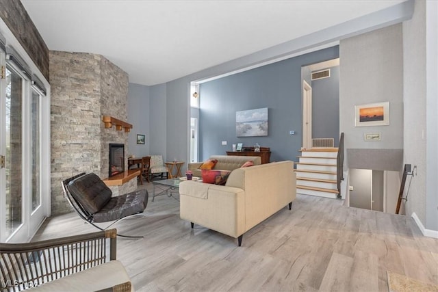 living room featuring a fireplace and light hardwood / wood-style flooring