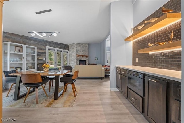 dining space with a fireplace and light wood-type flooring