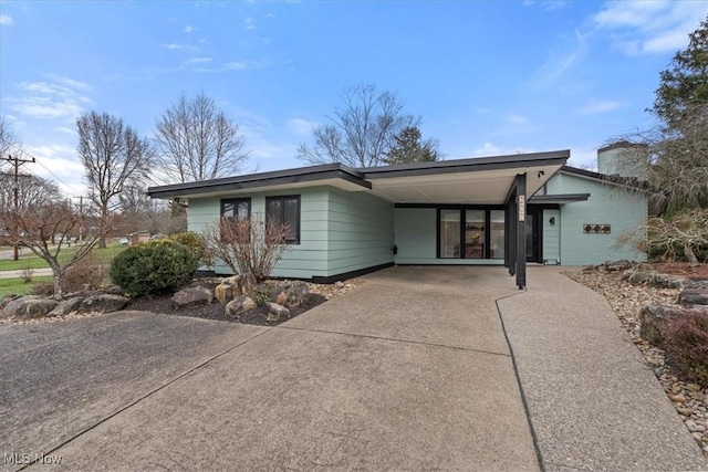 ranch-style house featuring a carport