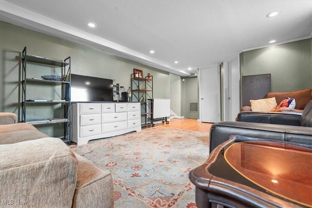 living room with light hardwood / wood-style floors and ornamental molding