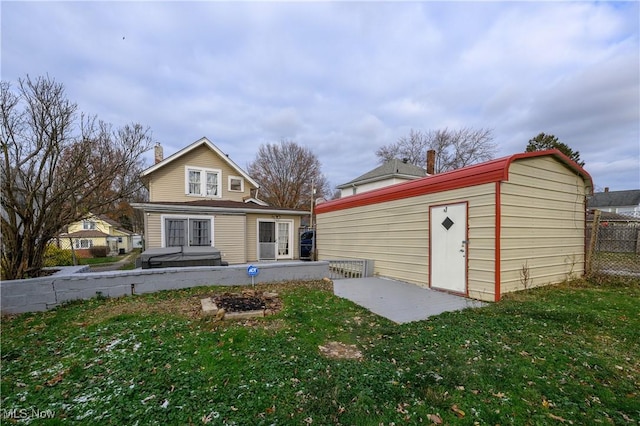 rear view of property featuring a yard