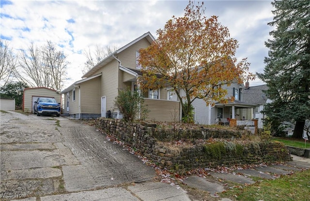 view of side of property featuring an outbuilding and a garage