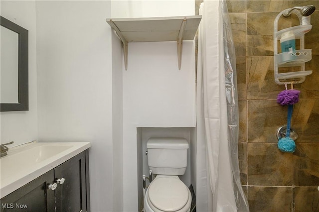 bathroom with vanity, a shower with shower curtain, and toilet