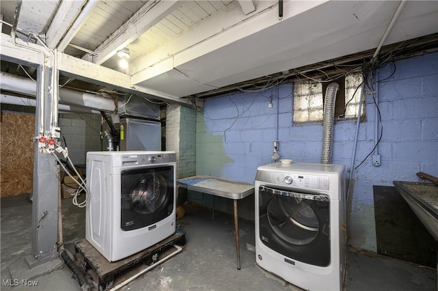 clothes washing area with separate washer and dryer