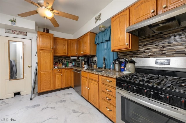 kitchen with stone counters, sink, ceiling fan, tasteful backsplash, and stainless steel appliances