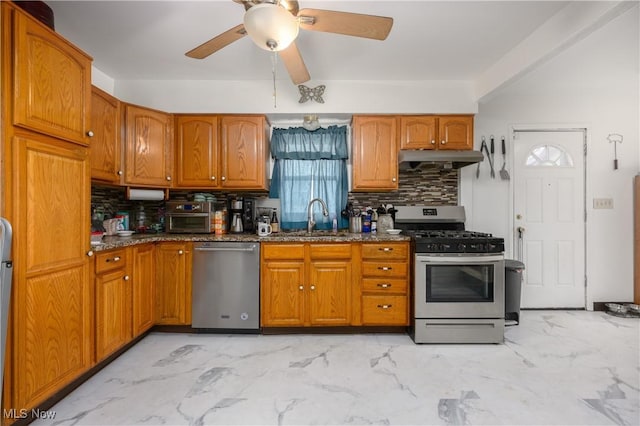 kitchen featuring backsplash, stainless steel appliances, dark stone counters, and sink