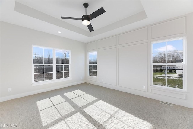 583 Iris Pl, Aurora, OH 44202 - spare room featuring a tray ceiling, light colored carpet, a ceiling fan, and recessed lighting