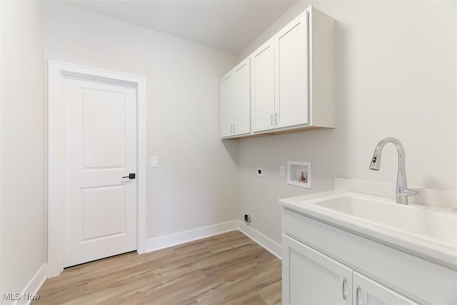583 Iris Pl, Aurora, OH 44202 - laundry room featuring cabinet space, hookup for an electric dryer, hookup for a washing machine, and light wood finished floors