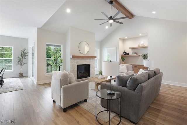 583 Iris Pl, Aurora, OH 44202 - living area with a tiled fireplace, light wood-style floors, beamed ceiling, recessed lighting, and ceiling fan