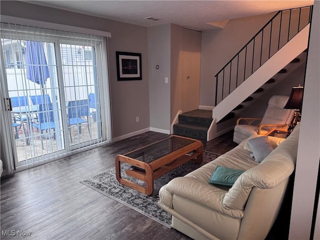 living room with dark hardwood / wood-style flooring