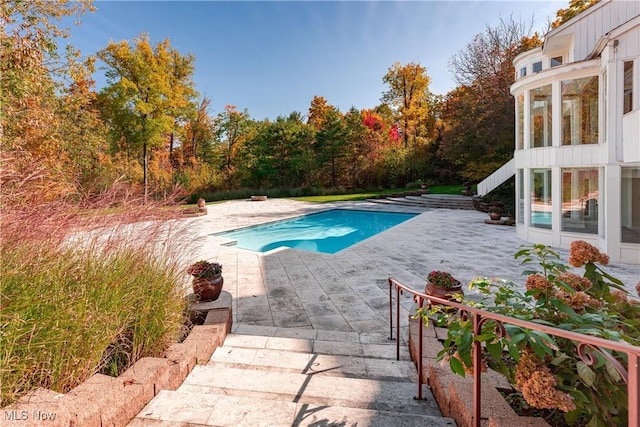 view of swimming pool with a patio