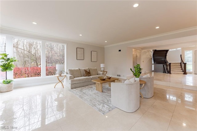 living room featuring a wealth of natural light, light tile patterned floors, and ornamental molding