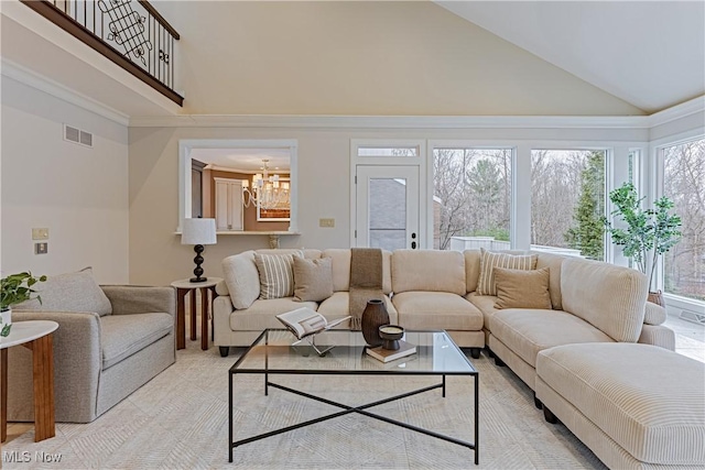 living room with an inviting chandelier and high vaulted ceiling