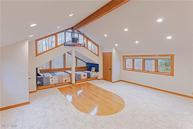 unfurnished living room with vaulted ceiling with beams and light carpet