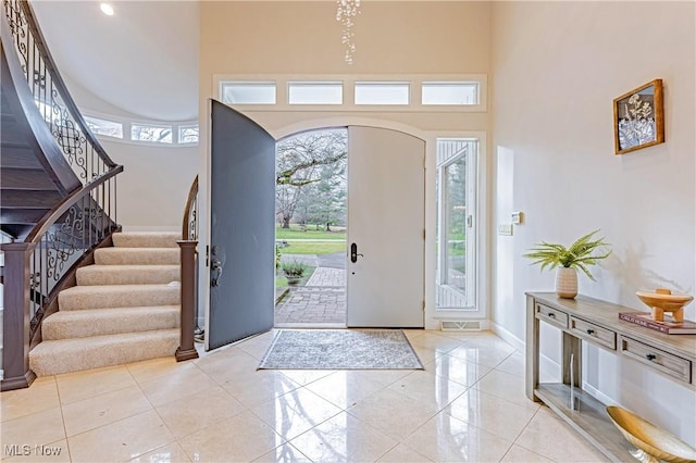 entrance foyer featuring a towering ceiling