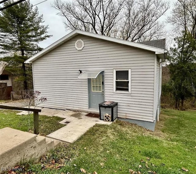 rear view of house with a yard