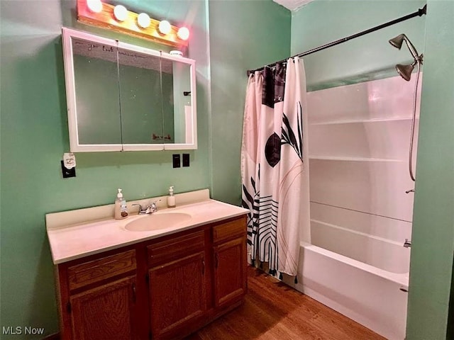 bathroom featuring hardwood / wood-style floors, vanity, and shower / tub combo with curtain