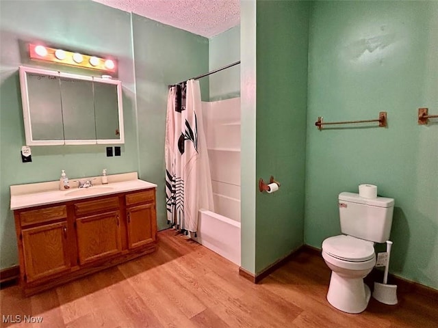 full bathroom featuring wood-type flooring, a textured ceiling, toilet, shower / tub combo with curtain, and vanity