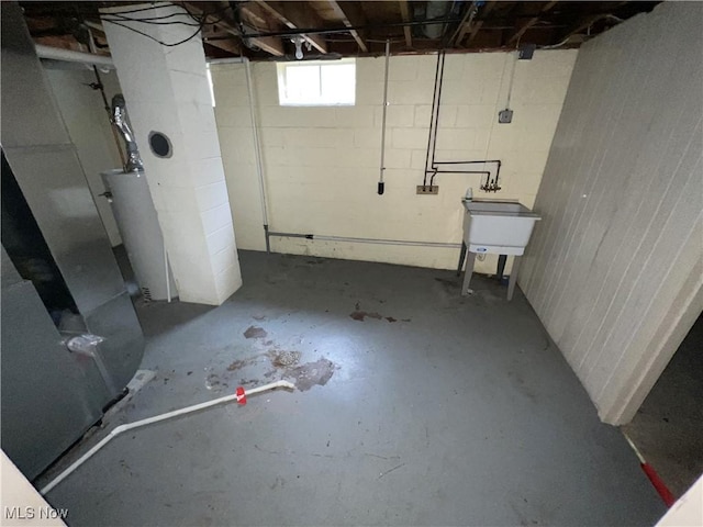 basement featuring water heater and sink