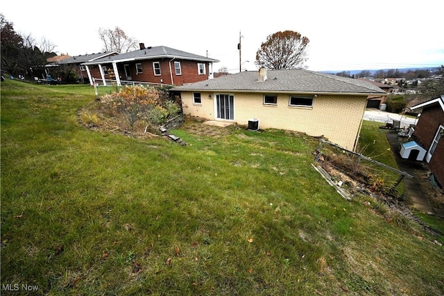 back of house with a lawn