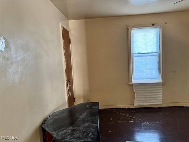 empty room with dark wood-type flooring