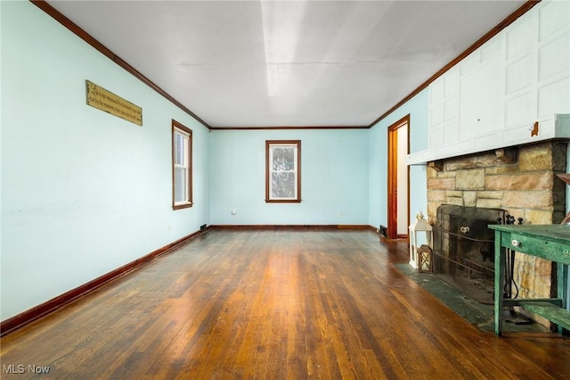 unfurnished living room with a fireplace, dark hardwood / wood-style floors, and ornamental molding