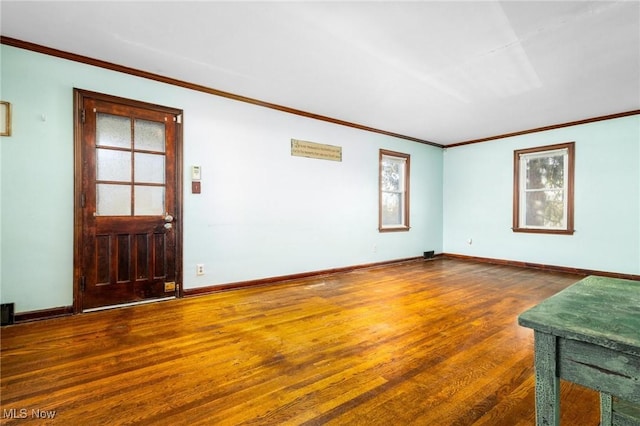 unfurnished living room with ornamental molding and dark wood-type flooring