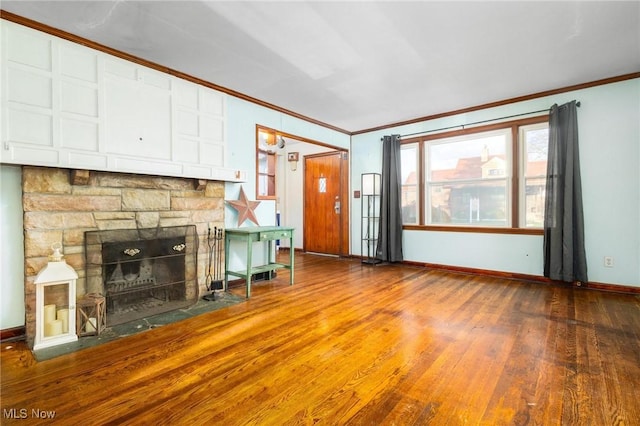 unfurnished living room featuring wood-type flooring, a stone fireplace, and crown molding